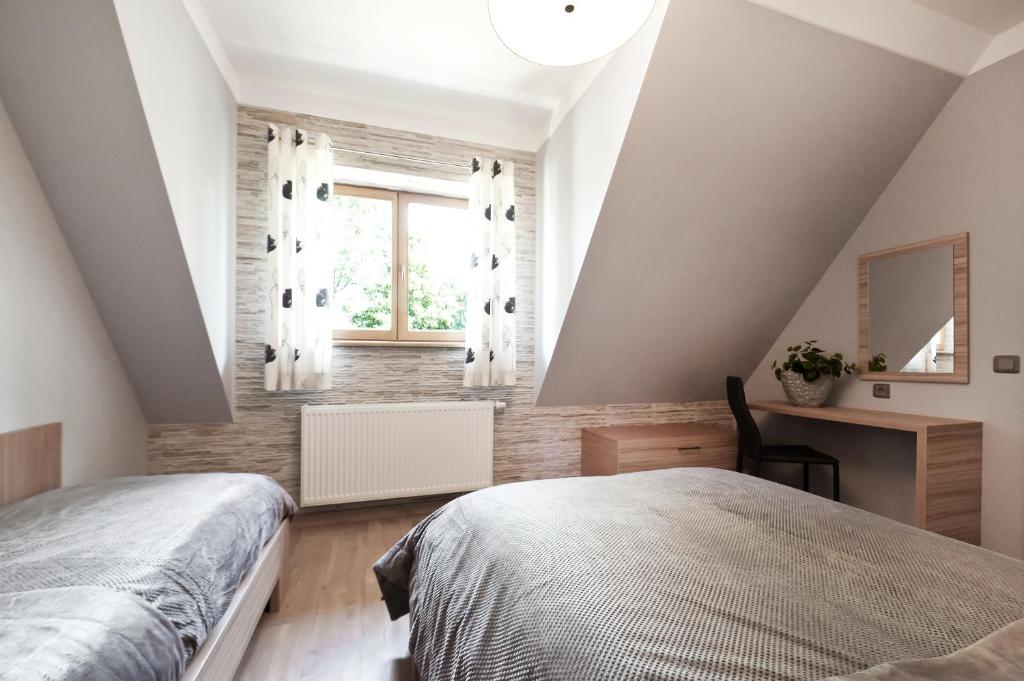 Posteľ alebo postele v izbe v ubytovaní Apartamenty Sun & Snow Lipki Park Zakopane
