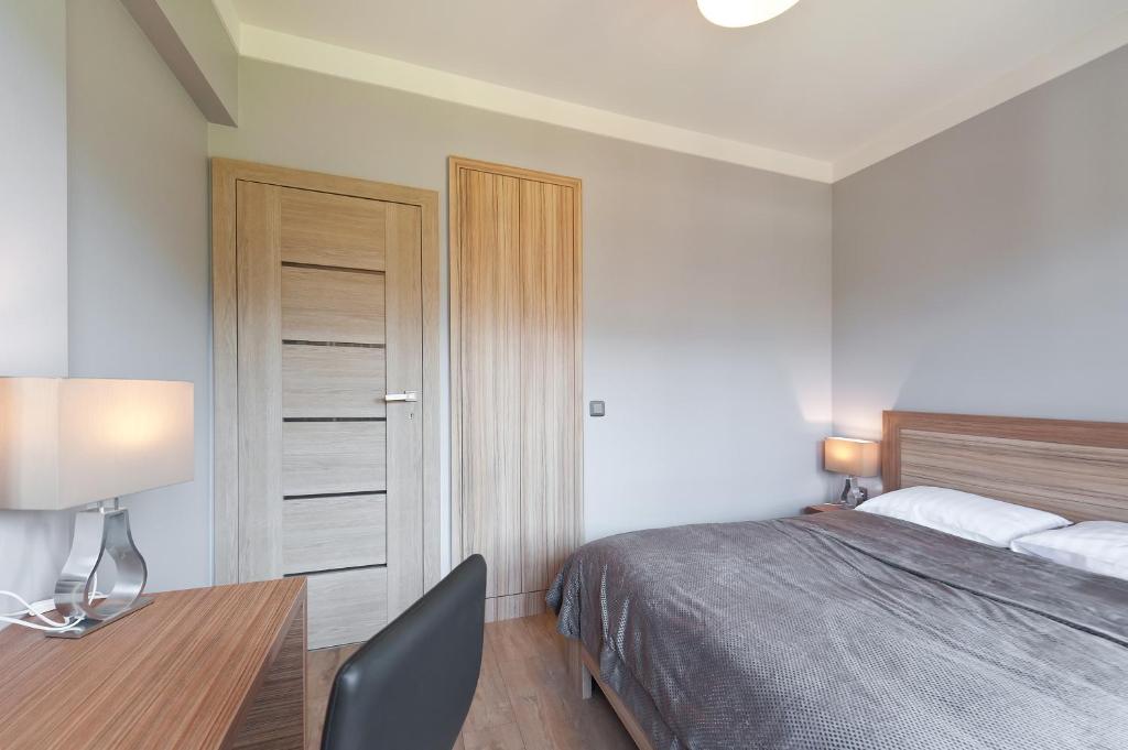 Posteľ alebo postele v izbe v ubytovaní Apartamenty Sun & Snow Lipki Park Zakopane