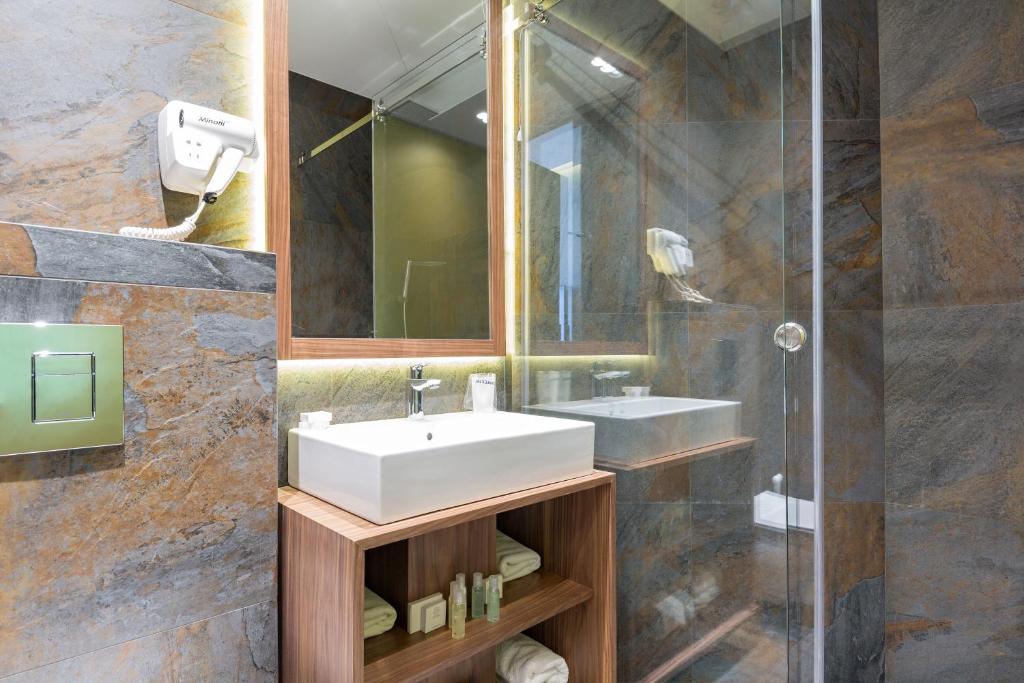 a bathroom with a sink and a shower at Five Points Square - City Center in Belgrade