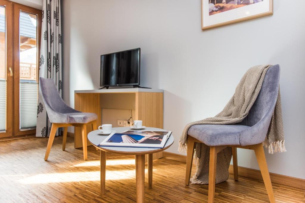 Televízia a/alebo spoločenská miestnosť v ubytovaní Apartamenty Sun & Snow Resorts Lipki Park z sauną