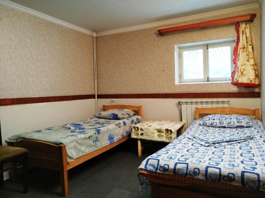 a bedroom with two beds and a window at Hostel Sakharov & Tours in Yerevan