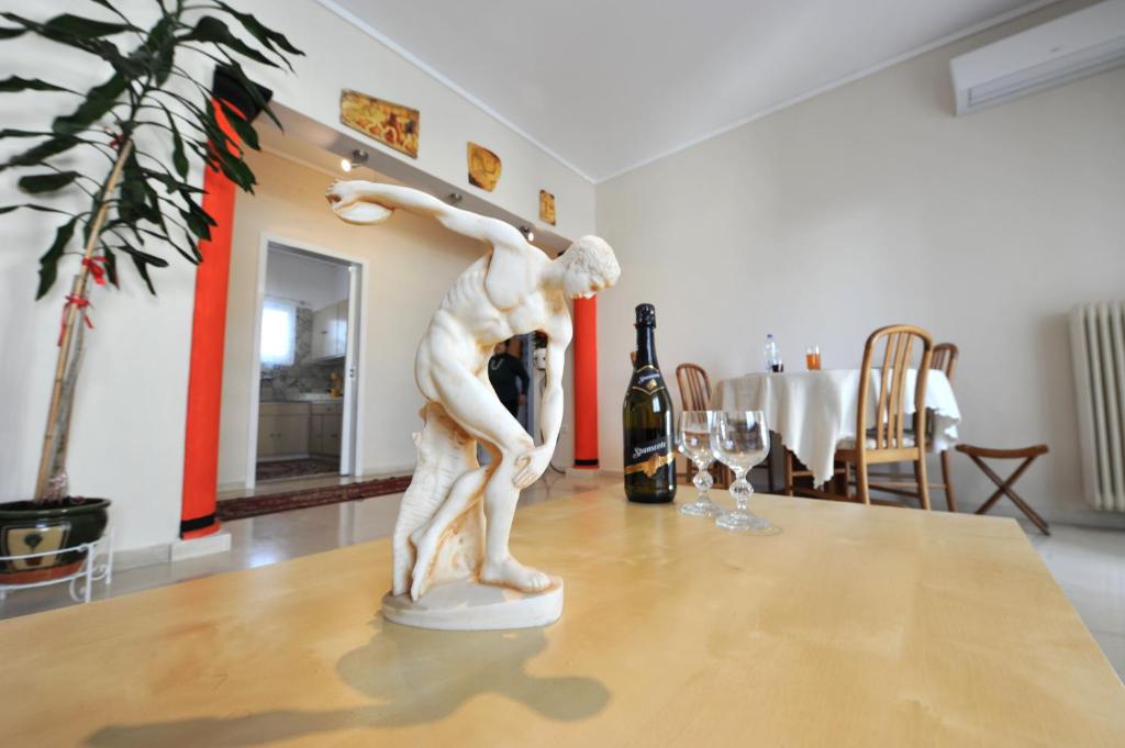 a statue of a woman dancing on a table at Apartment near Stavros Niarchos Park & Acropolis in Athens