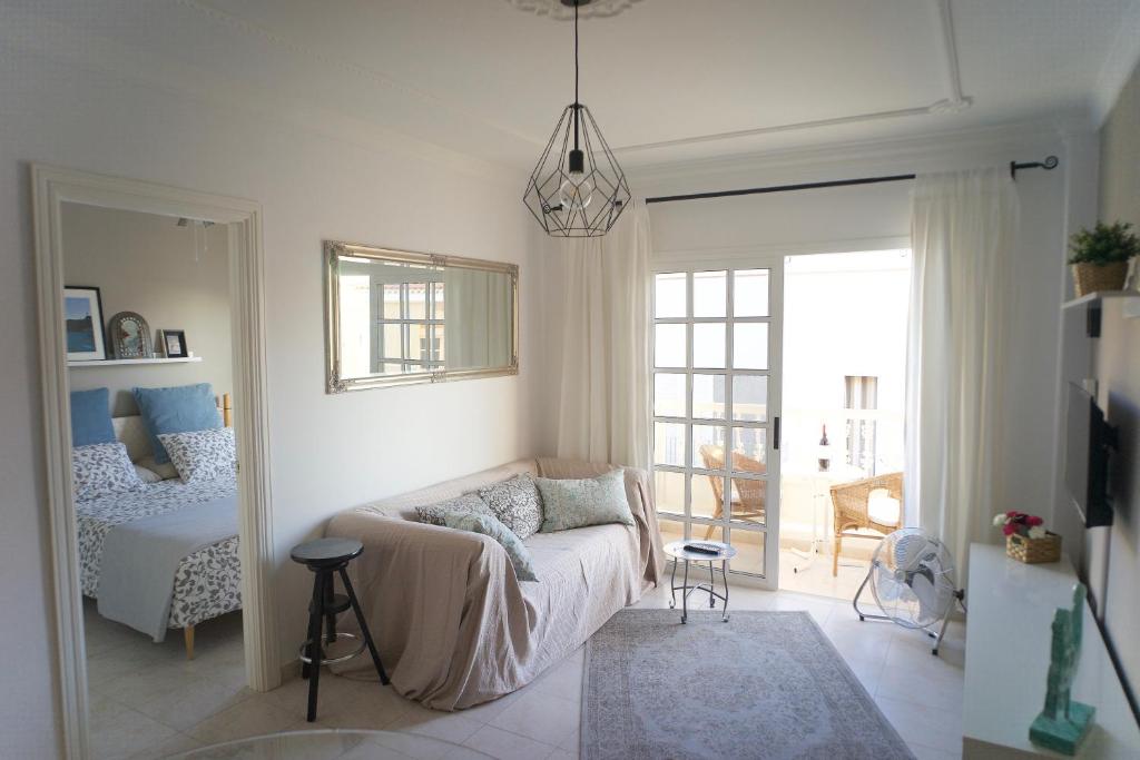 a living room with a couch and a bedroom at Casa del Mar in Playa de San Juan