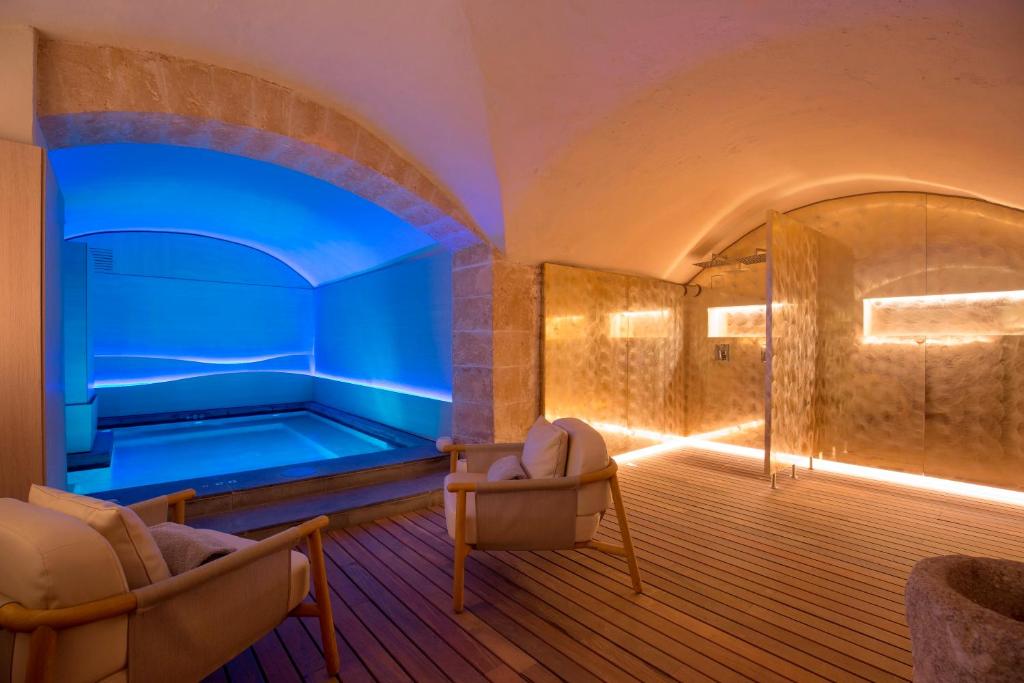 a room with a tub with two chairs in front of it at Convent de la Missio - Grand Luxury Boutique hotel, Adults Only in Palma de Mallorca