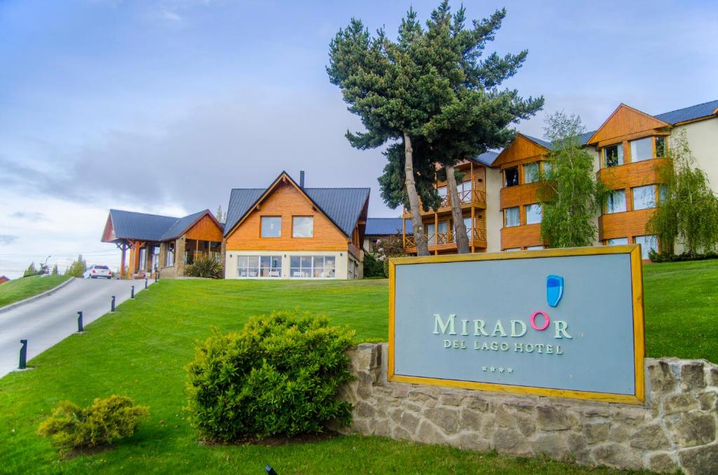 a house with a sign on the front of it at Mirador del Lago Hotel in El Calafate