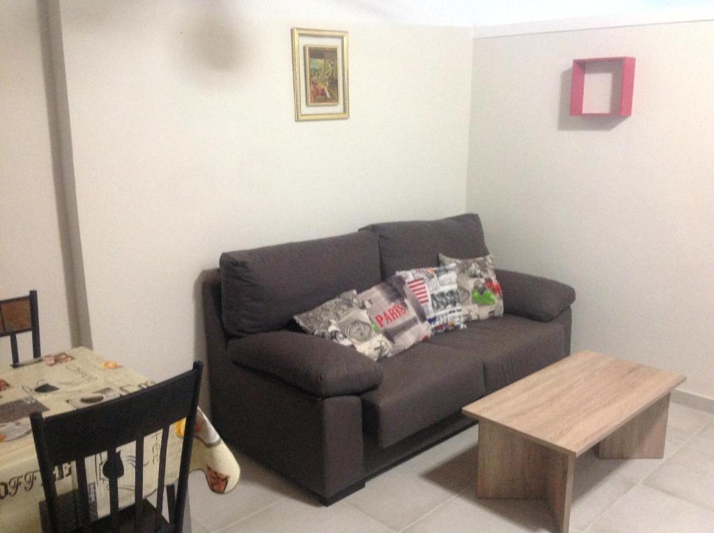 a living room with a couch and a table at La Siesta Casa Jenni in Benidorm