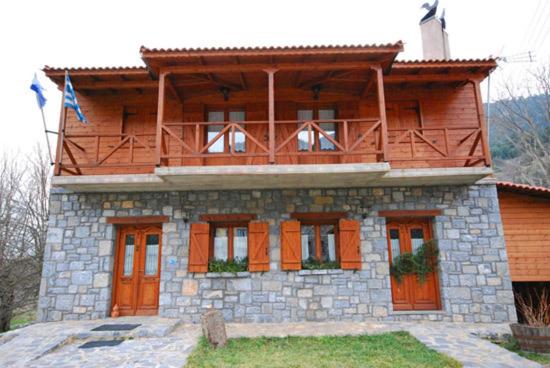 a house with a balcony on top of it at Guesthouse Alonistaina in Alonistaina