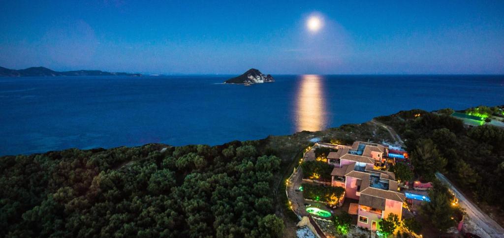 an aerial view of a resort on the ocean at night at Athenea Villas Private pools & private gardens individual in Keri