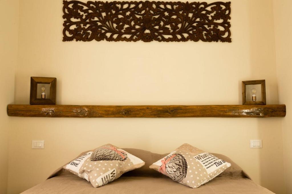 two pillows on top of a bed in a room at La corte dei tre in Torre del Lago Puccini