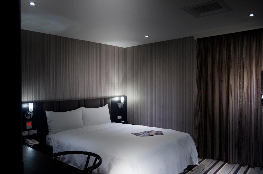 Postel nebo postele na pokoji v ubytování Grace Hotel