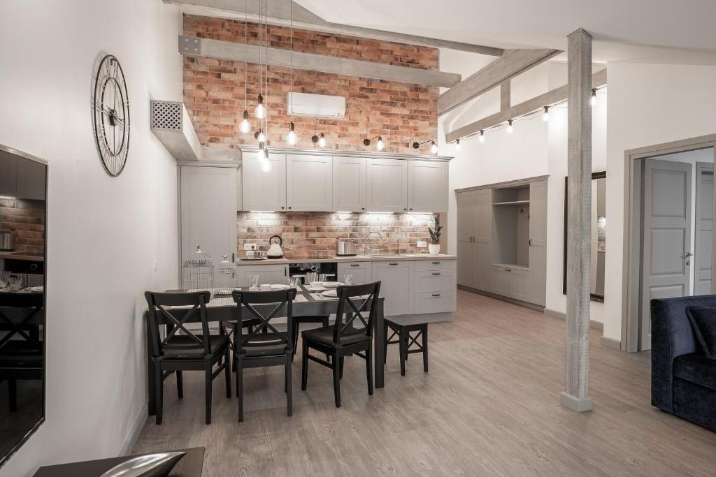 a kitchen and dining room with a table and chairs at Comfort Stay - Klaipeda in Klaipėda