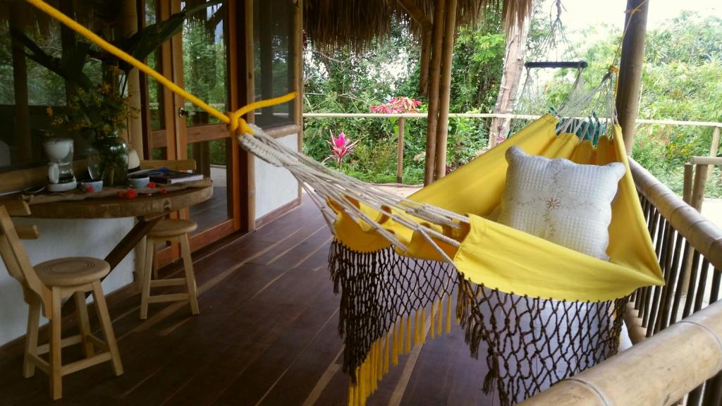 a hammock in a room with a table at Minca Glamping in Minca