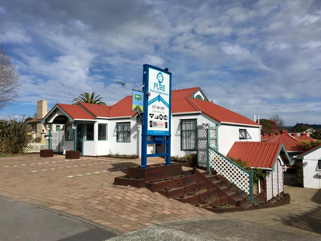 a gas station with a sign in front of it at Pure Motel in Rotorua
