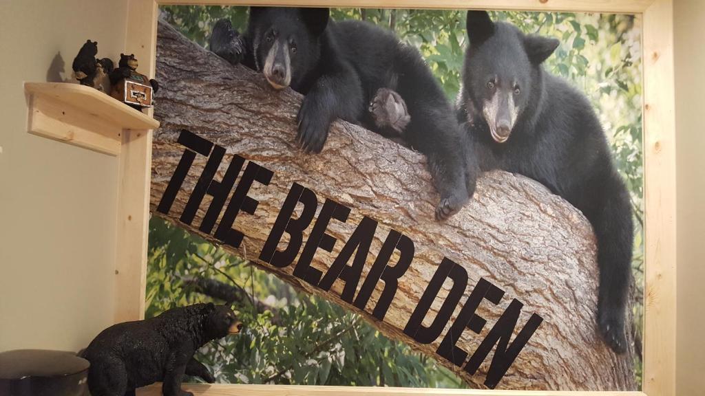 a picture of three black bears on a tree at Bear Cove Inn in Saint Ignace