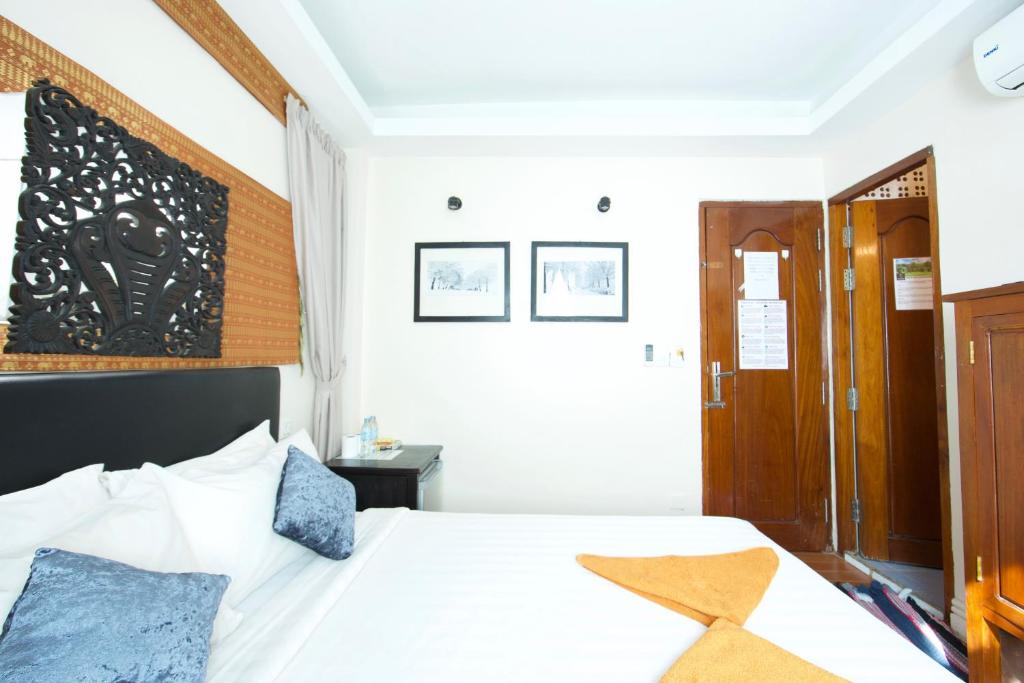 Postel nebo postele na pokoji v ubytování Naga Angkor Hostel