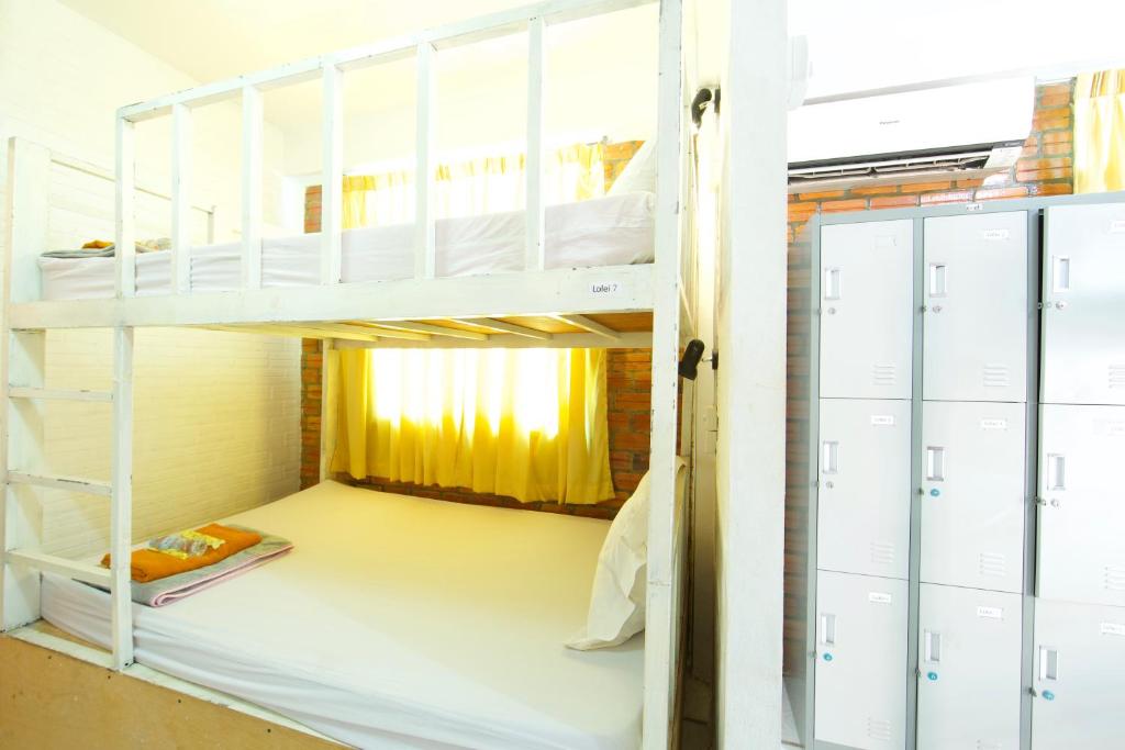 Postel nebo postele na pokoji v ubytování Naga Angkor Hostel