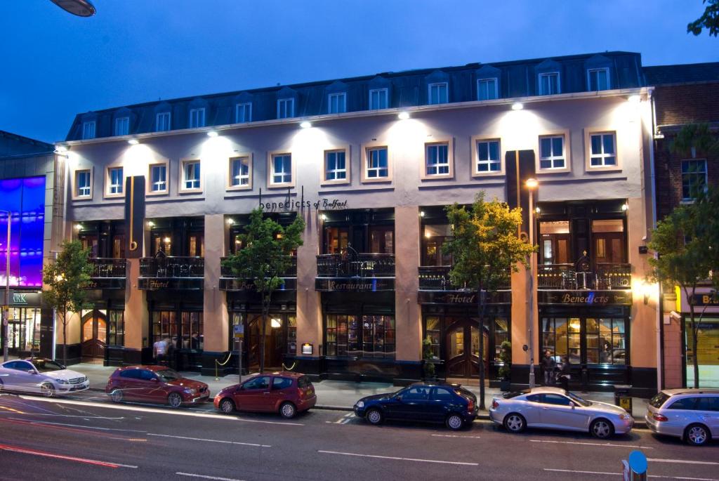 a large building with cars parked in front of it at Benedicts Hotel in Belfast
