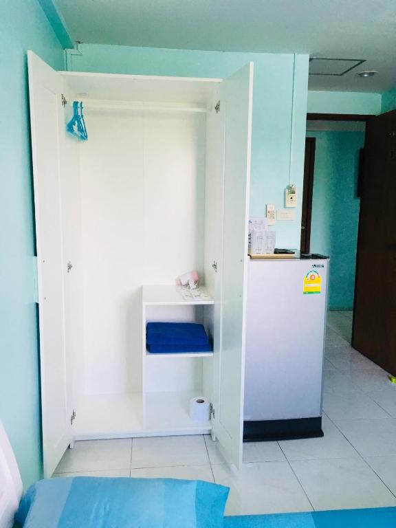 a small kitchen with a white refrigerator in a room at Best Rent a Room in Nai Yang Beach