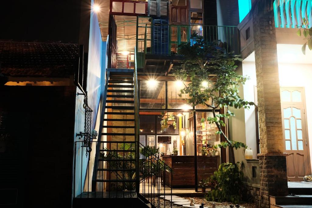 a staircase leading up to a building at night at Yellow Farm homestay in Ðông Tác (1)