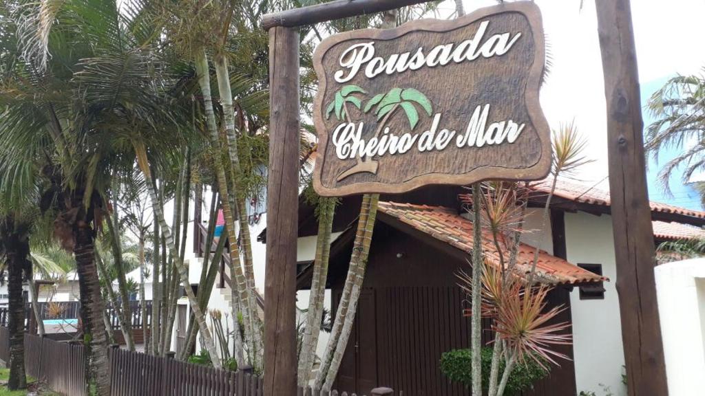 a sign for a restaurant in front of a building at Pousada Cheiro De Mar in Imbituba