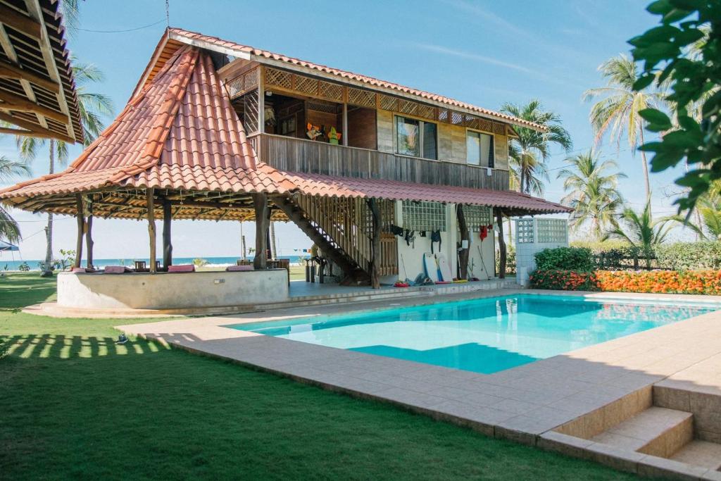 a house with a swimming pool in front of a house at Totobe Resort in Jabilla