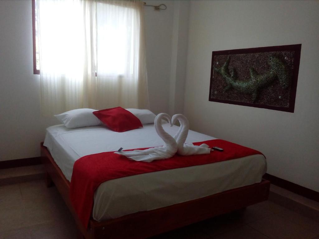 Postel nebo postele na pokoji v ubytování Hostal El Pinzón