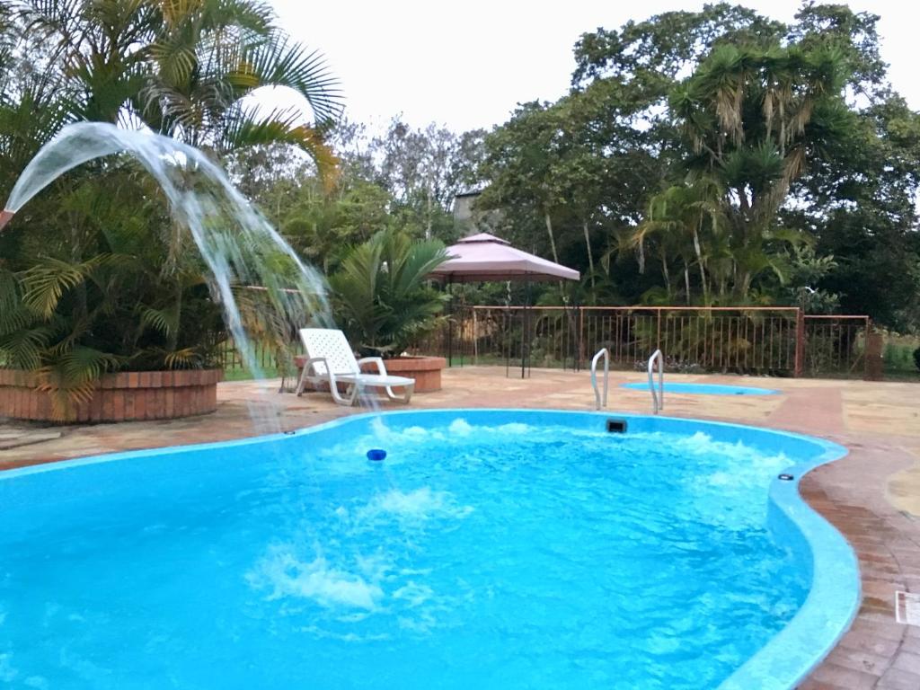 a swimming pool with a water fountain at Cabañas La Carolina - Mesa de Los Santos in Los Santos