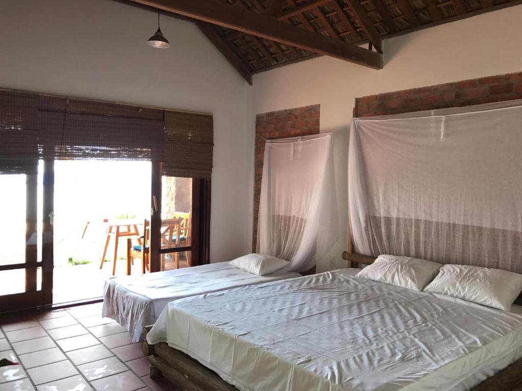 Postel nebo postele na pokoji v ubytování Phu Quoc Kim 2 Beach Front Resort