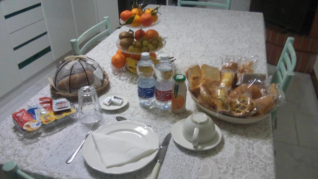 a white table with food and drinks on it at B&B La Casa di Elsa in Marina di Massa