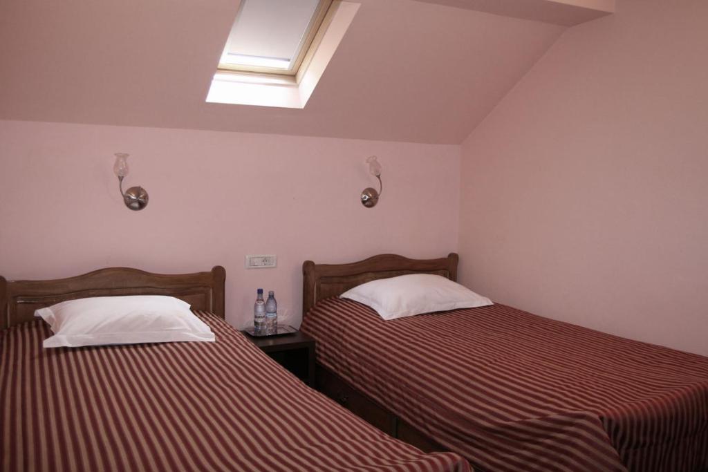 Postel nebo postele na pokoji v ubytování Hotel Kilometrul Zero
