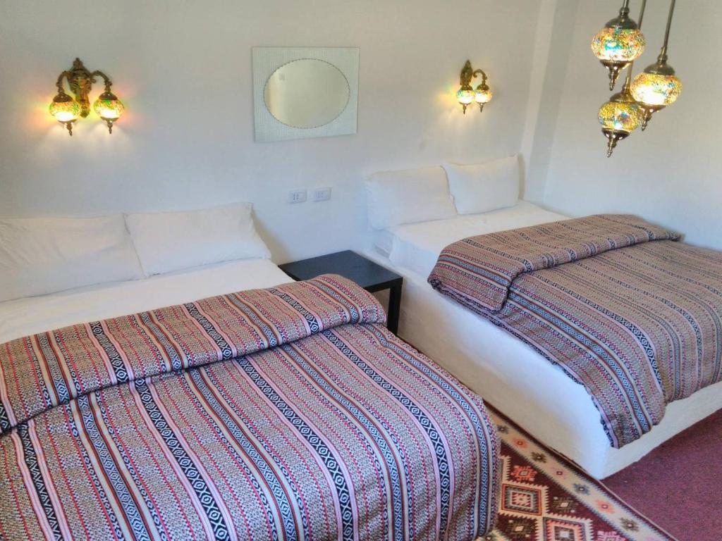 a room with two beds in a room at Petra Bedouin Bed and Breakfast in Wadi Musa