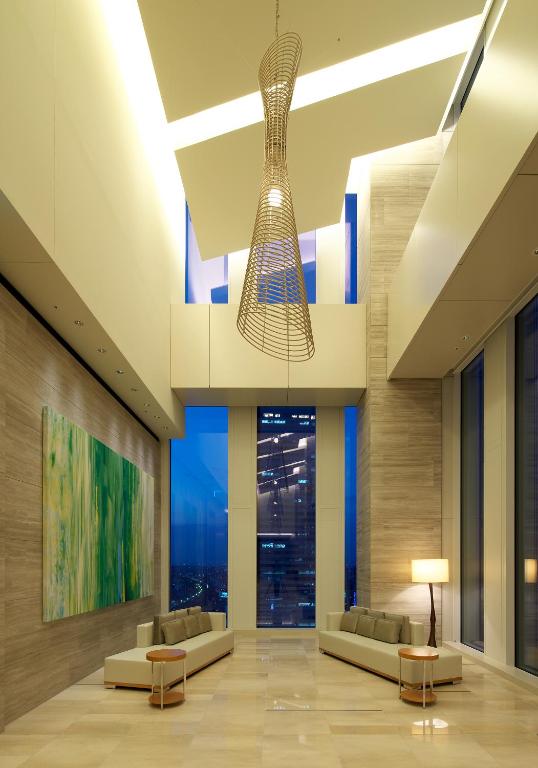 a lobby with couches and a chandelier at Nagoya JR Gate Tower Hotel in Nagoya