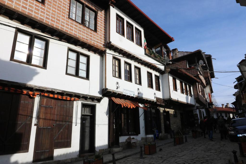 a group of white buildings on a street at Guest House Divna in Veliko Tŭrnovo