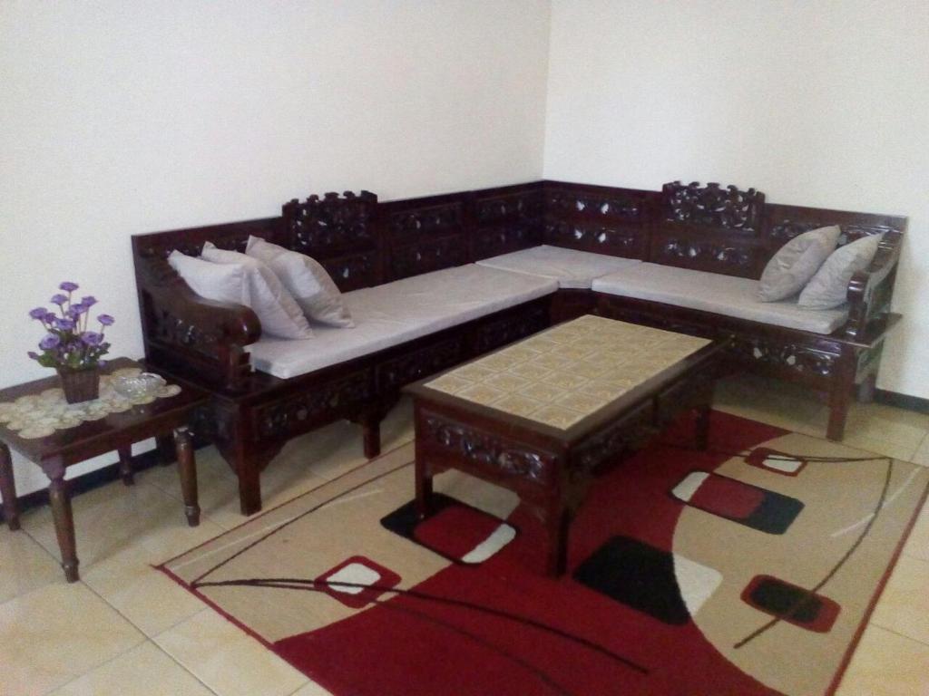 a living room with a couch and a table at Azalea Homestay in Batu