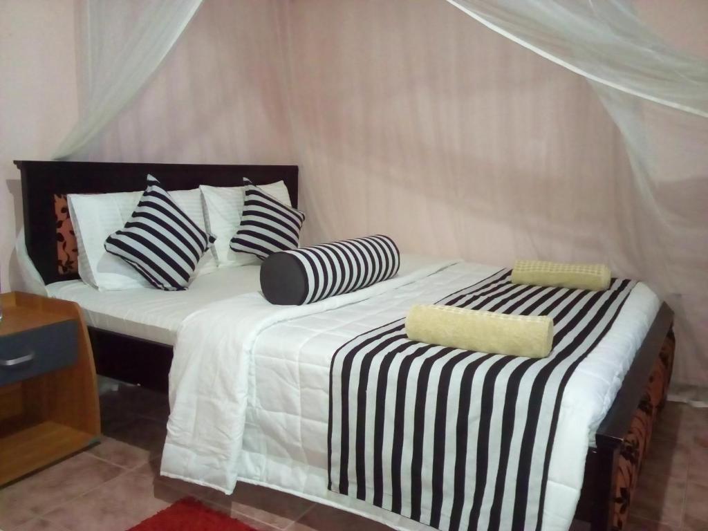 Postel nebo postele na pokoji v ubytování Blue Ribbon Homestay