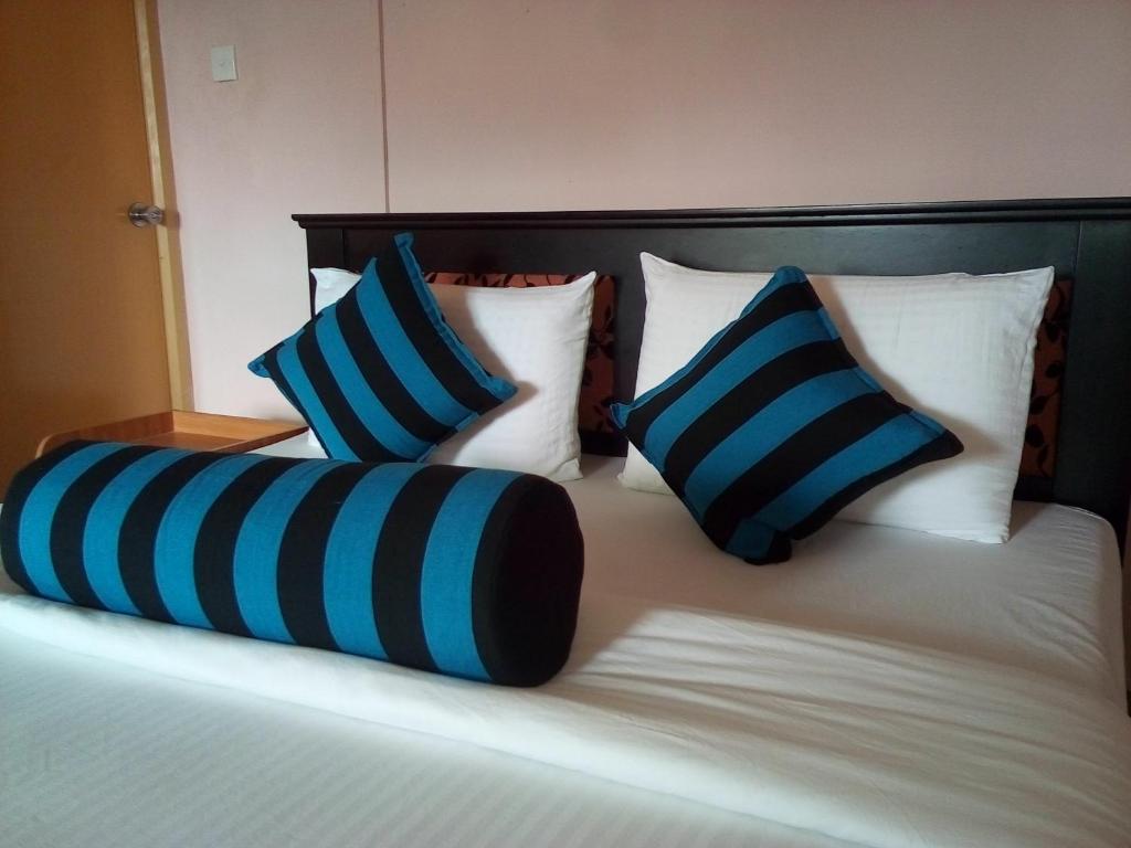 Postel nebo postele na pokoji v ubytování Blue Ribbon Homestay