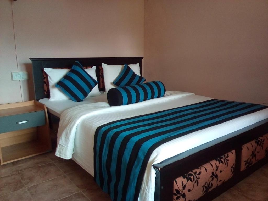 Postel nebo postele na pokoji v ubytování Blue Ribbon Homestay