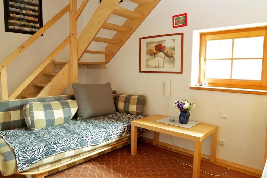 a living room with a couch and a staircase at Ferienwohnung Bacher in Edling