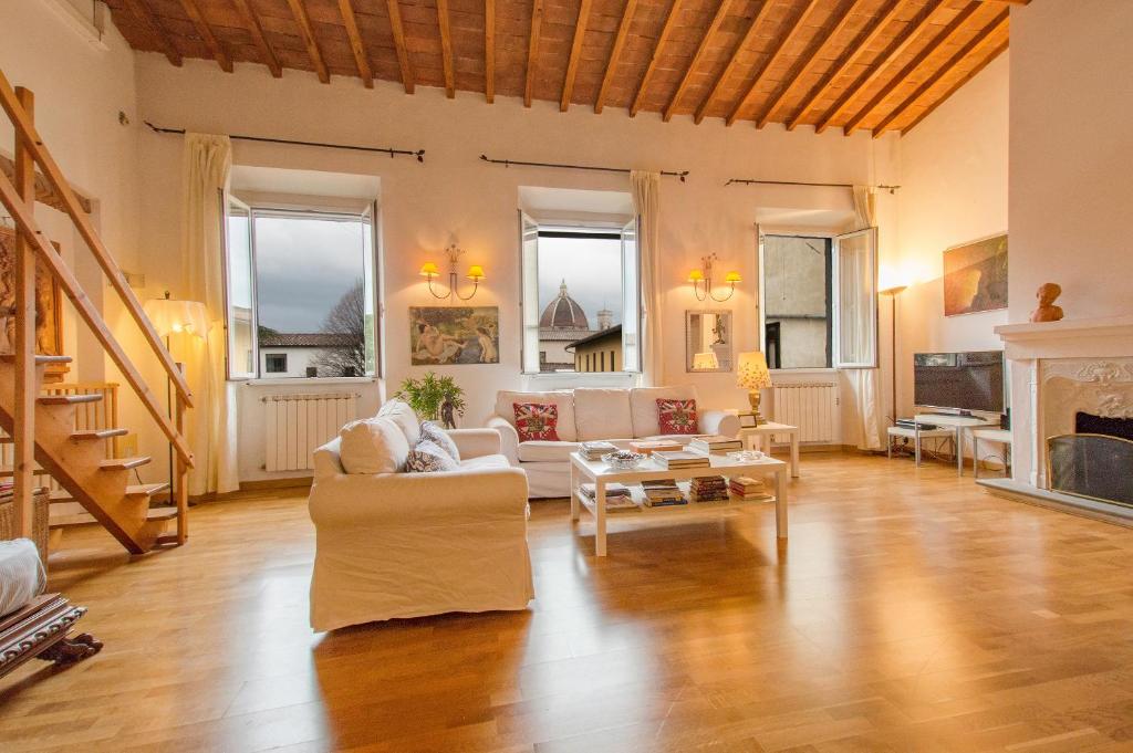 a living room filled with furniture and a fireplace at Appartamento Bellavista Firenze in Florence