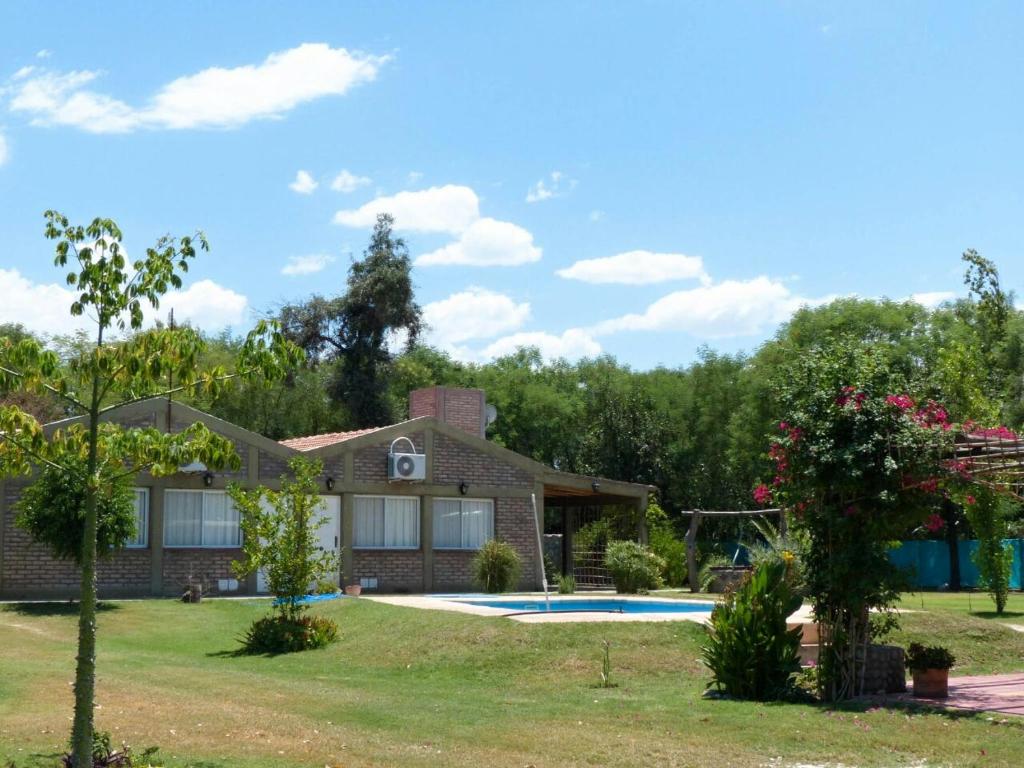 a house with a swimming pool in a yard at Cabañas La Rosita in San Agustín de Valle Fértil