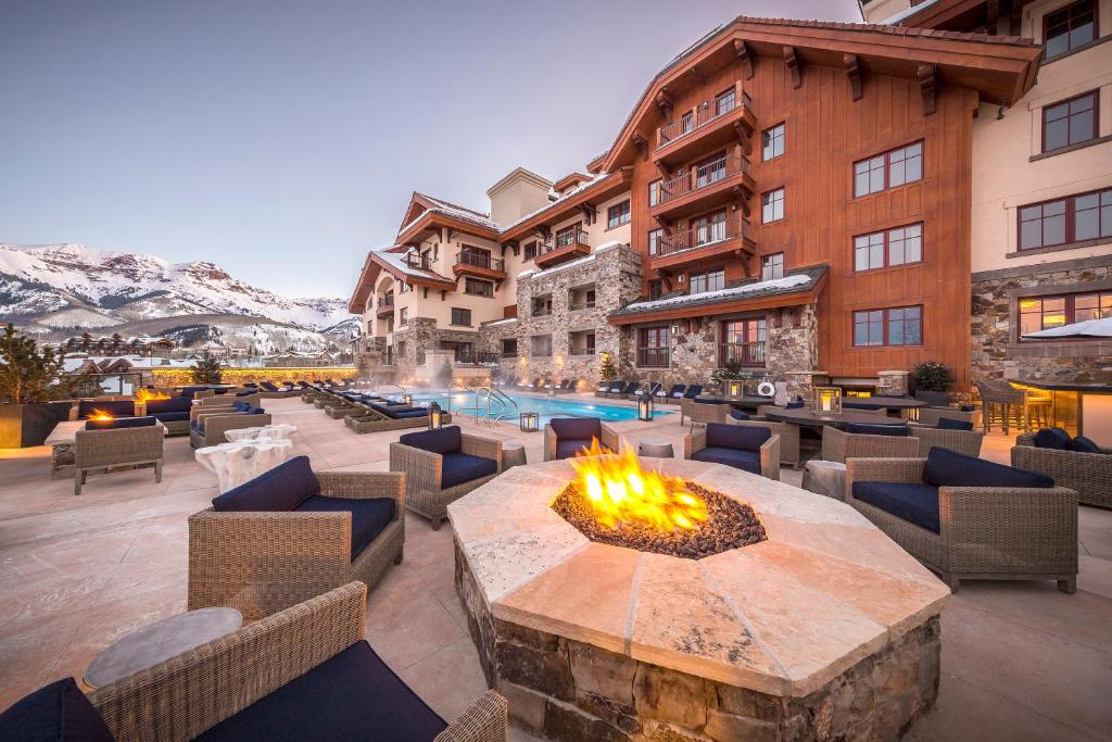 a hotel patio with a fire pit and a pool at Madeline Hotel and Residences, Auberge Resorts Collection in Telluride