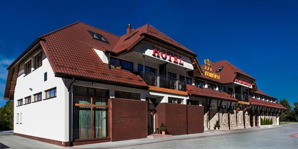 a large building with a red roof at Trzy Korony in Głogów Małopolski