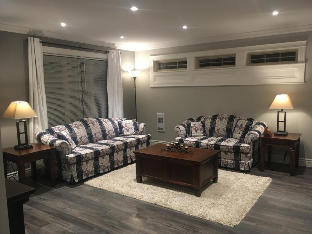 a living room with two couches and a coffee table at Quidi Vidi Retreat in St. John's