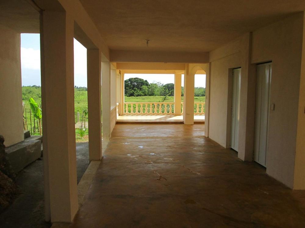 an empty hallway of a house with a balcony at Villa Mambo in Patrana