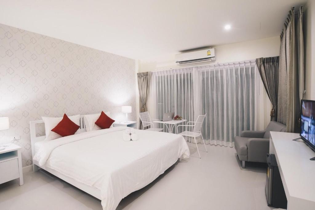 Postel nebo postele na pokoji v ubytování Shunli Hotel - SHA Extra Plus