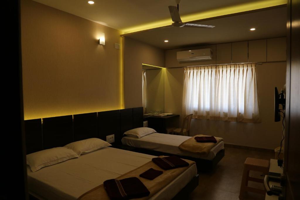 Ένα ή περισσότερα κρεβάτια σε δωμάτιο στο Navaratna Palace