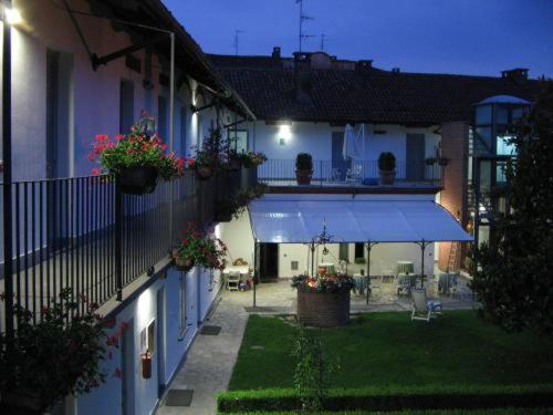 a courtyard of a house with a blue awning at Albergo Antica Dogana in Asti