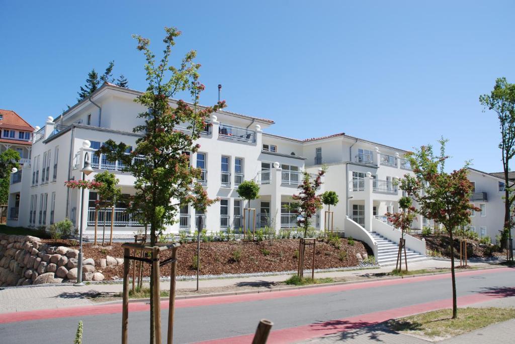 a row of white buildings on a street at Dünenresidenz Königin Augusta - Apt. 20 in Binz