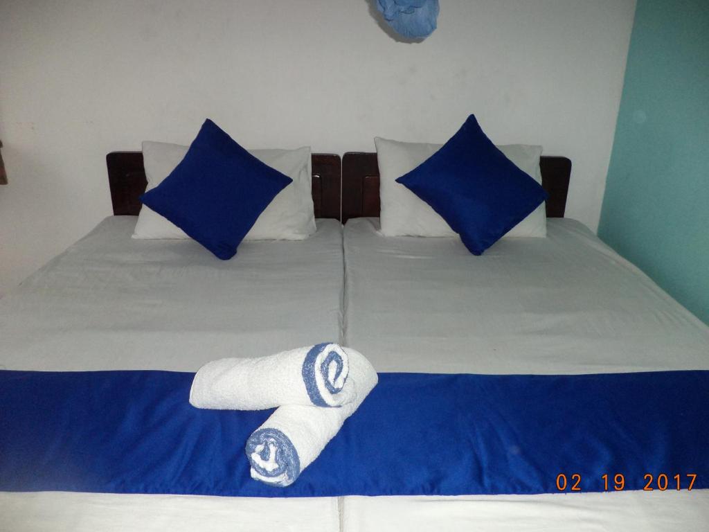 Postel nebo postele na pokoji v ubytování Raja174 Homestay