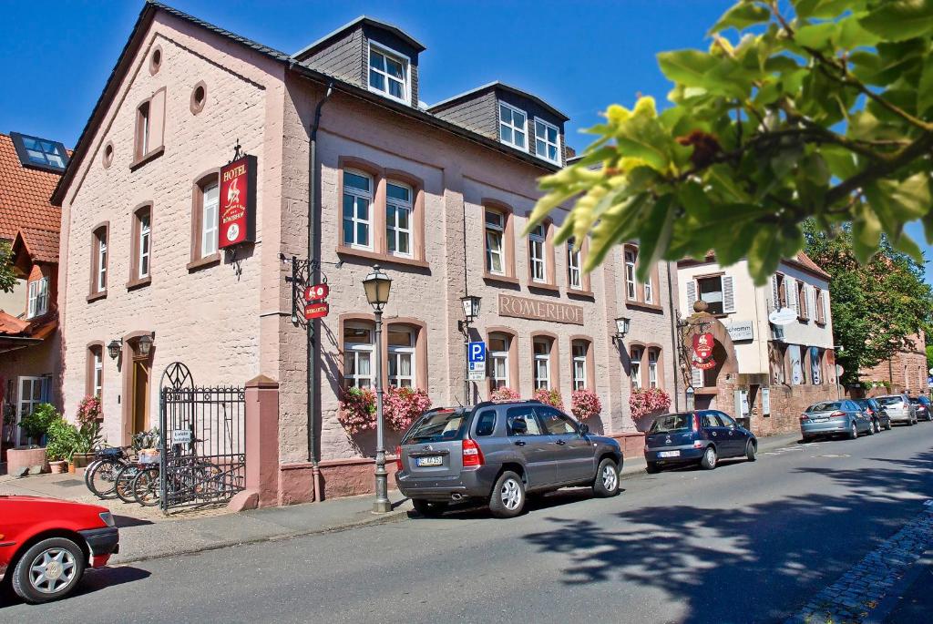 a street with cars parked in front of a building at Landgasthaus Römerhof in Obernburg am Main
